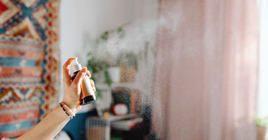 lady spraying home fragrance spray