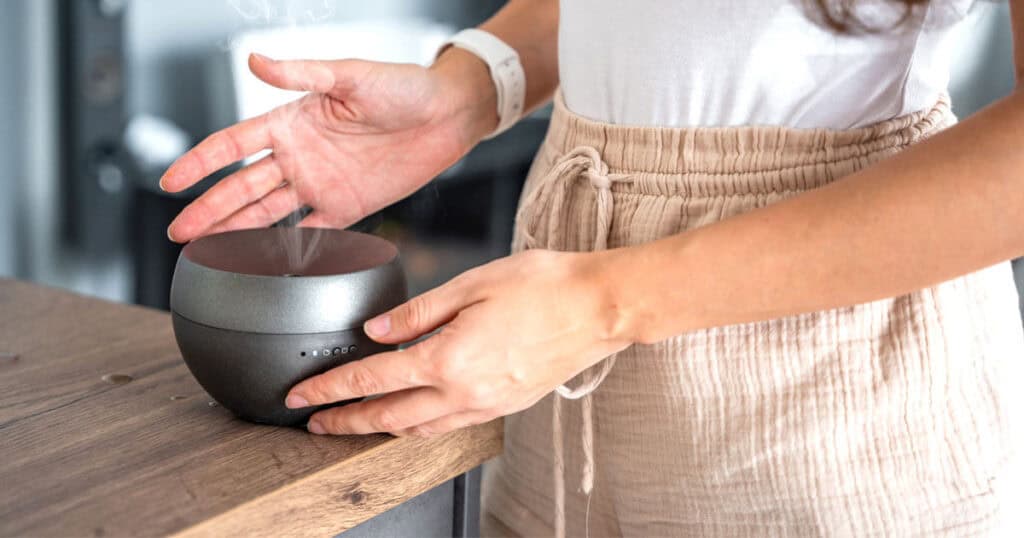 Are Essential Oils Safe for Your Lungs? VOCs and GC/MS Tested Brands 12 lady checking essential oil diffuser