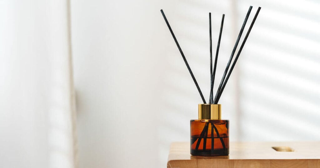 reed diffuser in a wooden shelf