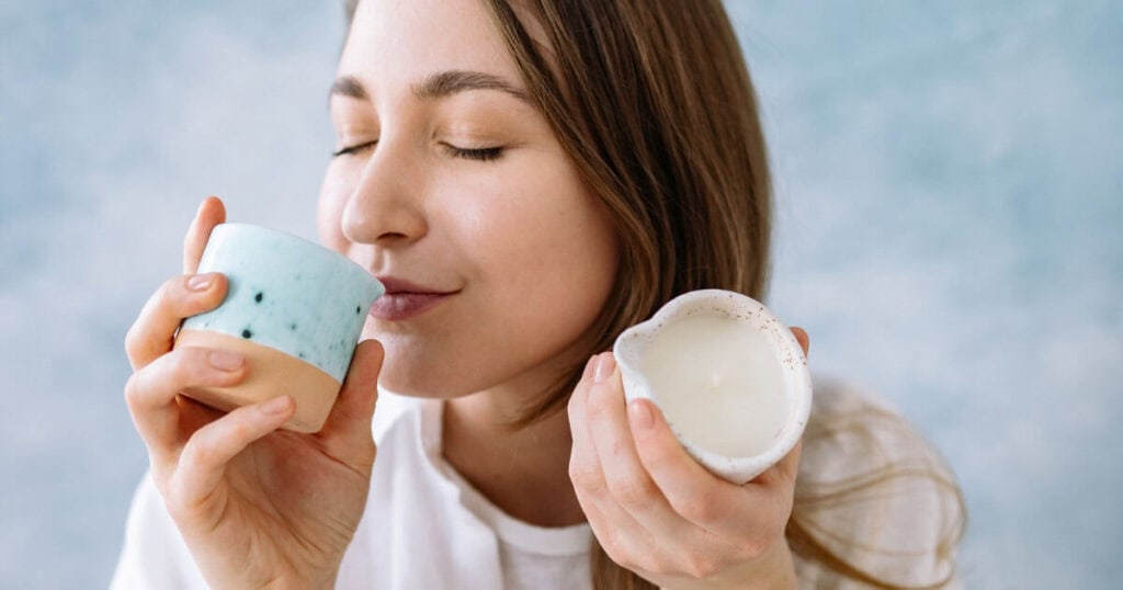 10 Best Candle Scents of 2026: Top Picks Loved by Real Buyers 11 lady smelling candle
