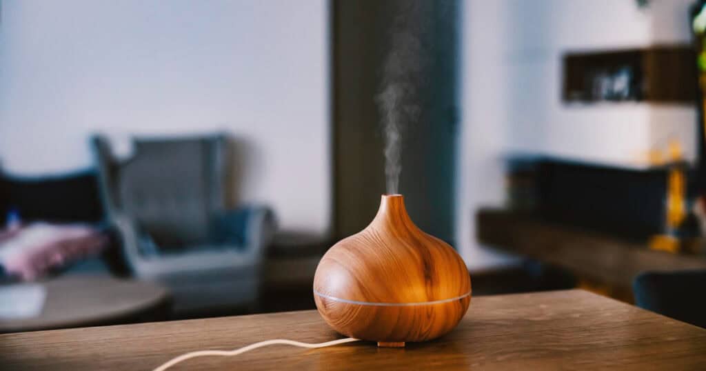 wooden essential oil diffuser in top of the wooden table